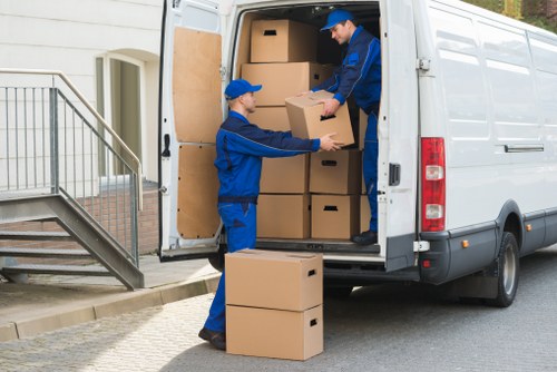 Removal team loading household furniture in a French city move