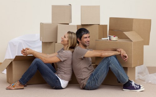 Removal team carrying furniture from an apartment with narrow access