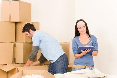 Worker using correct lifting technique with furniture
